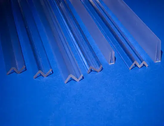 Clear extruded acrylic stock angles and channels on a blue background